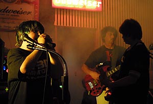 Hal Kopeikon, a professor in the UCSB Psychology Dept., plays bass in the I.V. garage band K, which includes his two sons Zak (middle) and Mason (left), with family friend Aaron on drums. The band, played Thursday at Giovanni's and rocked the house with an entertaining mix of original songs and crowd favorite cover songs by Weezer and Blink 182. Visit them at <a href=